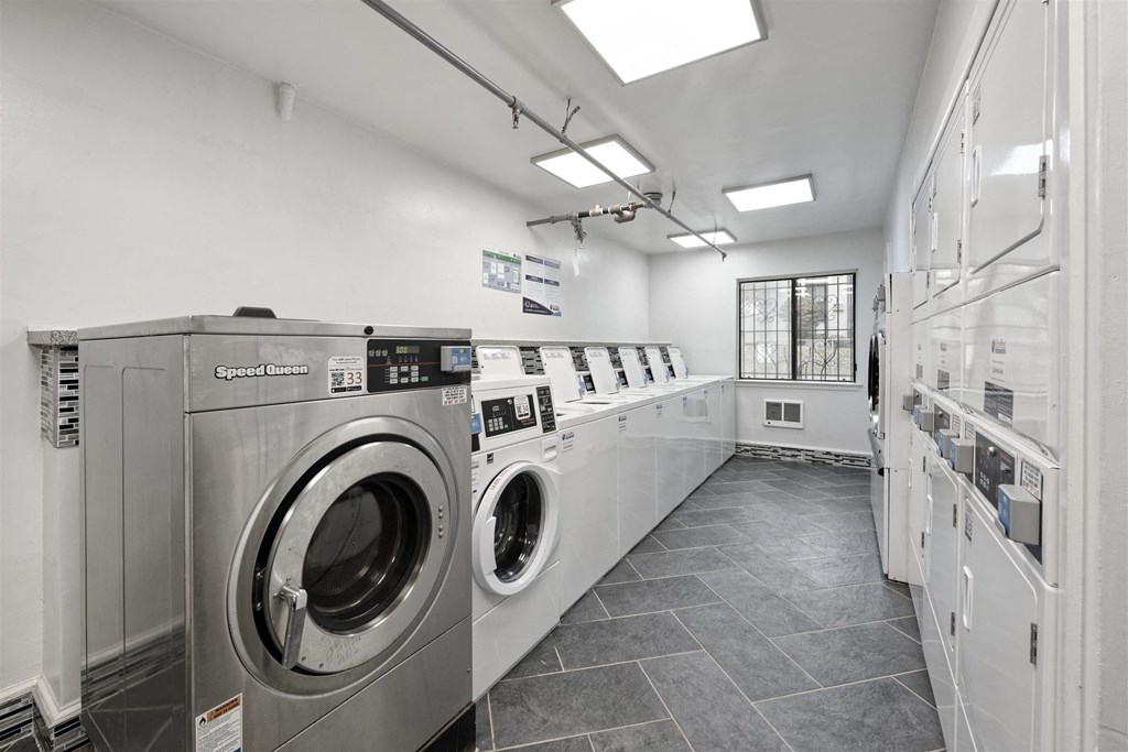A row of washing machines in a laundromat.
