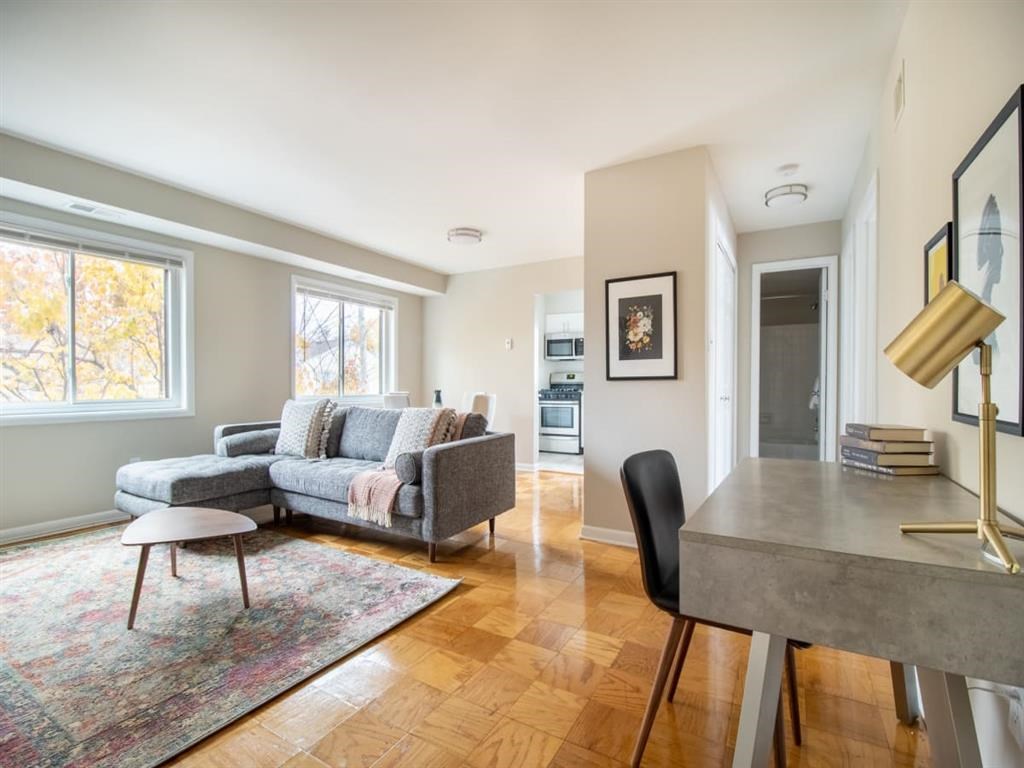 A living room with a grey couch and a grey table.