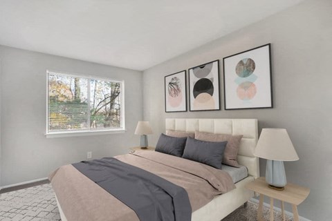 A bedroom with a large bed and three framed pictures on the wall.