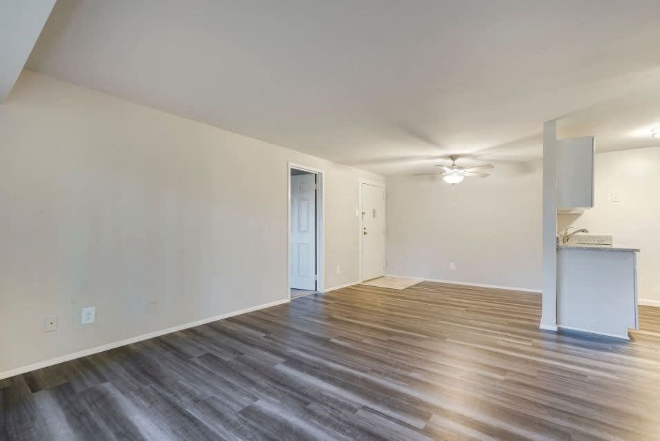A room with wooden flooring and a white cabinet.
