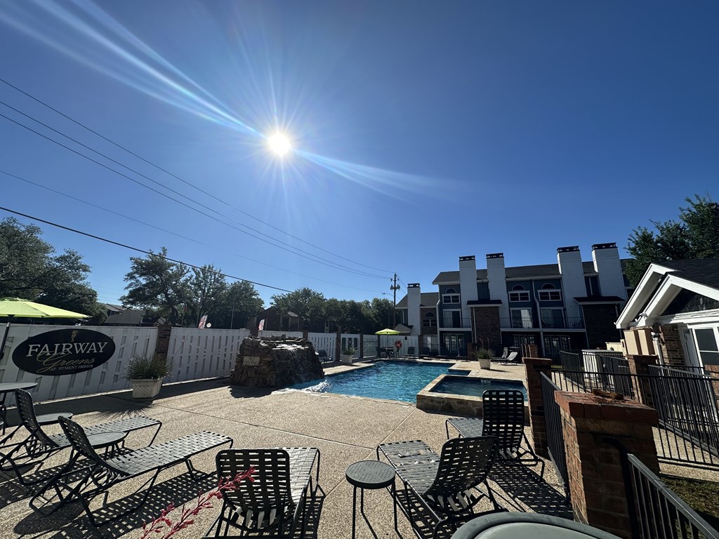 A sunny day at the Fairway pool area with chairs and tables arranged for relaxation.