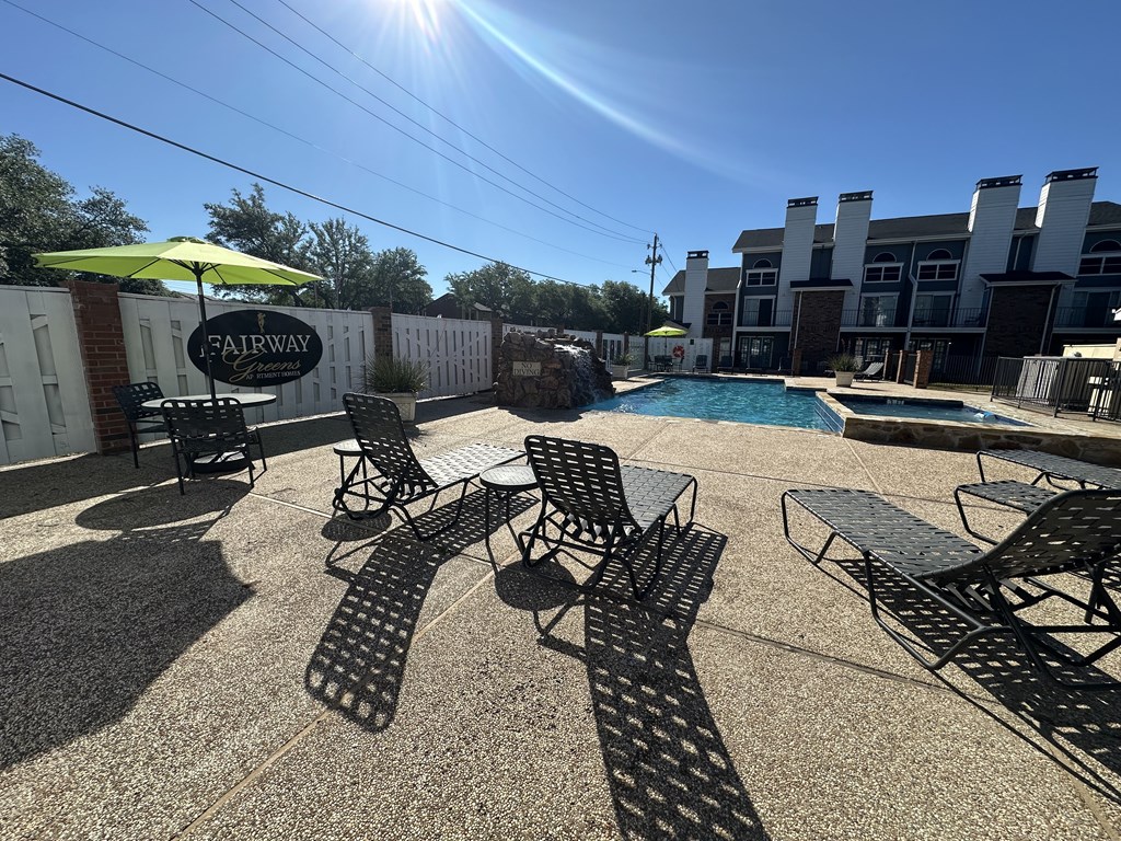 A pool area with chairs and a sign that says Fairway.