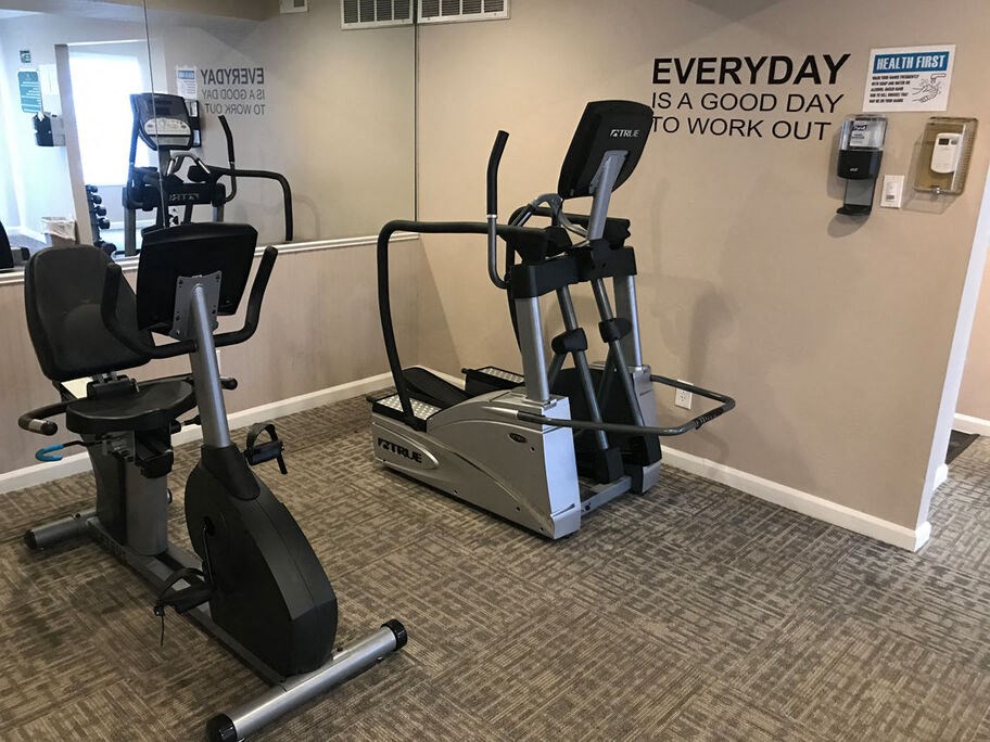 A gym room with a wall that says "Everyday is a good day to work out".