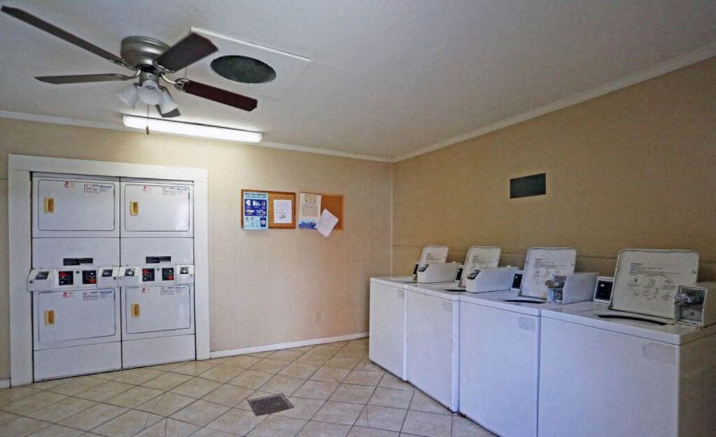 A room with a ceiling fan and a wall of mailboxes.
