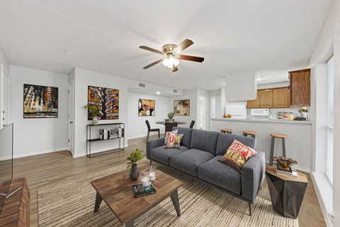 A living room with a grey couch and a wooden coffee table.