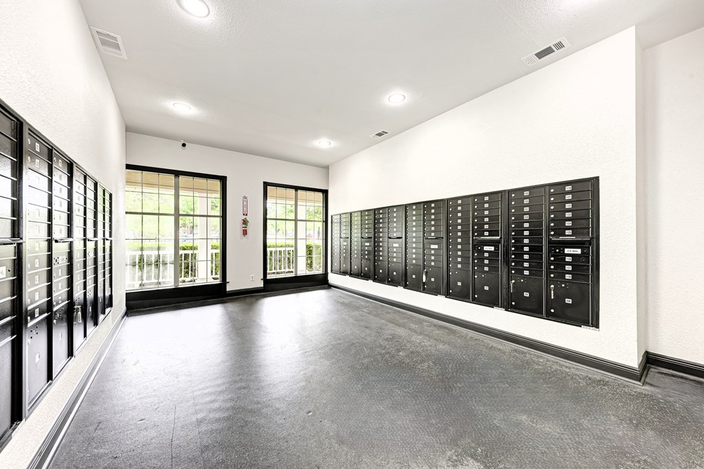 A living room with a fireplace and two striped ottomans.