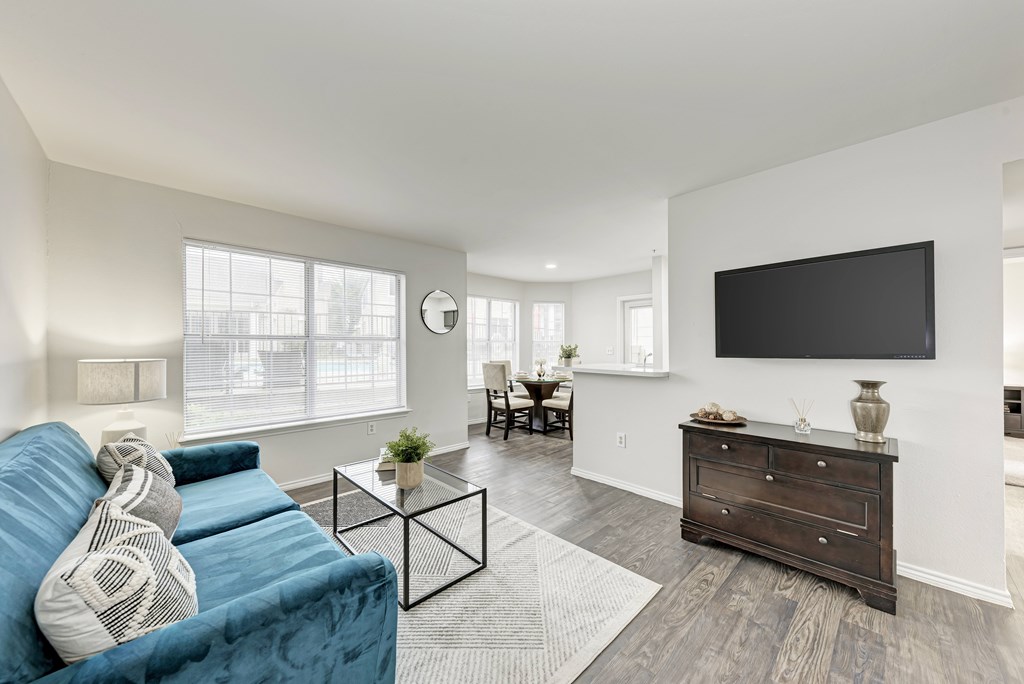 A gym with treadmills, elliptical machines, and a weight machine.