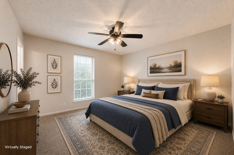 A bedroom with a bed, two nightstands, and a ceiling fan.