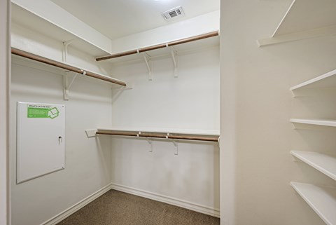 A white closet with a sign on the door.