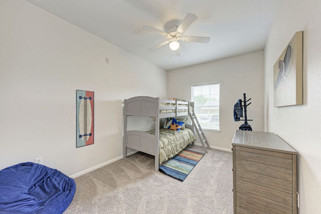 A bedroom with a bunk bed and a blue bean bag chair.