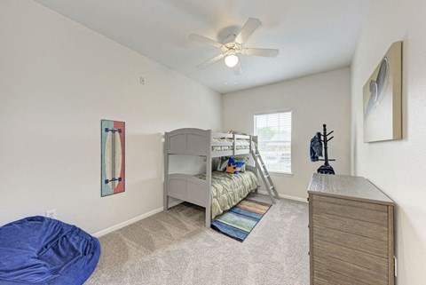 A bedroom with a bunk bed and a blue bean bag chair.