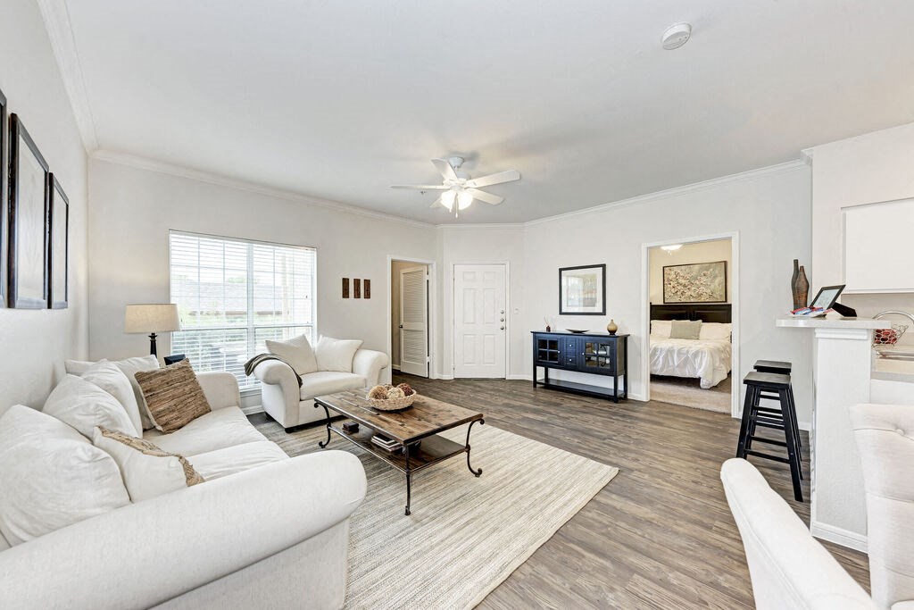 A living room with a white couch and a coffee table.