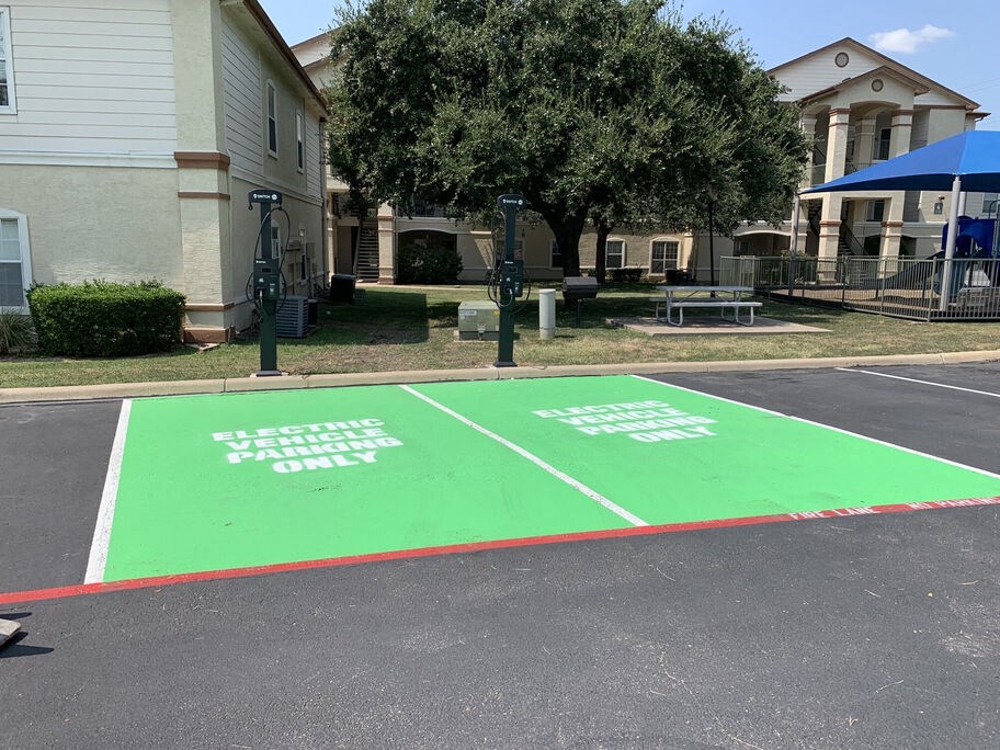 A parking lot with two green parking spaces for electors only.