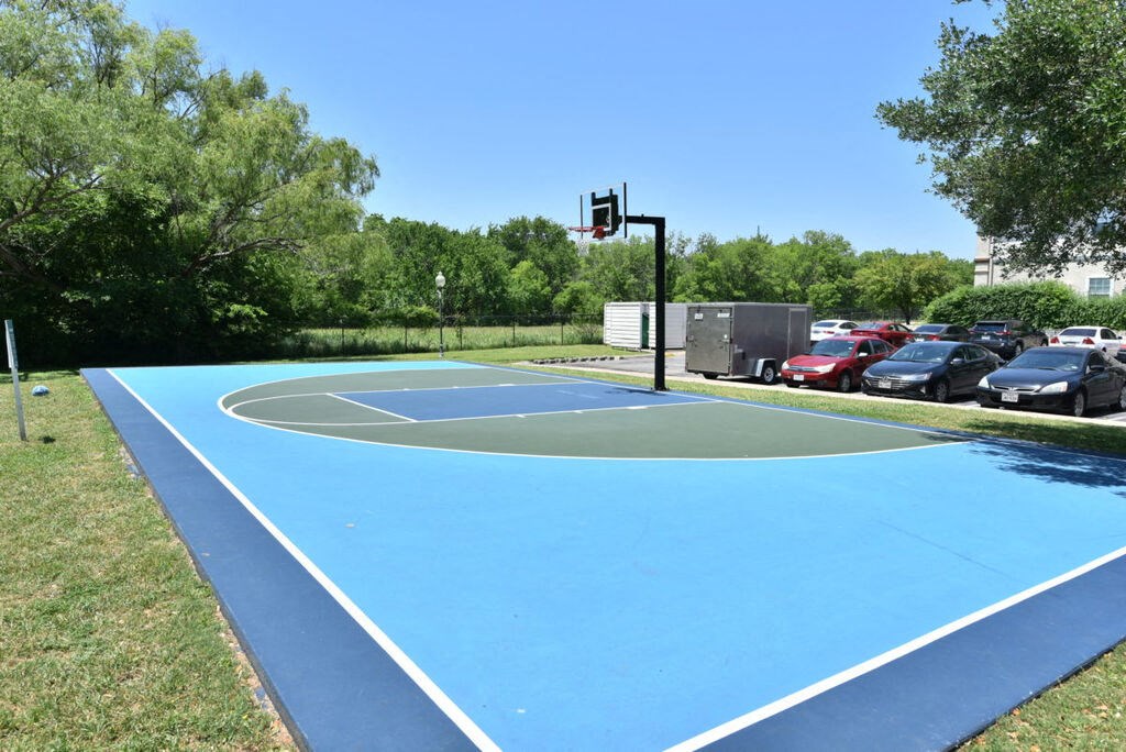 A basketball court with a blue surface and white lines.