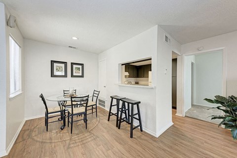 A dining room with a white table and chairs.