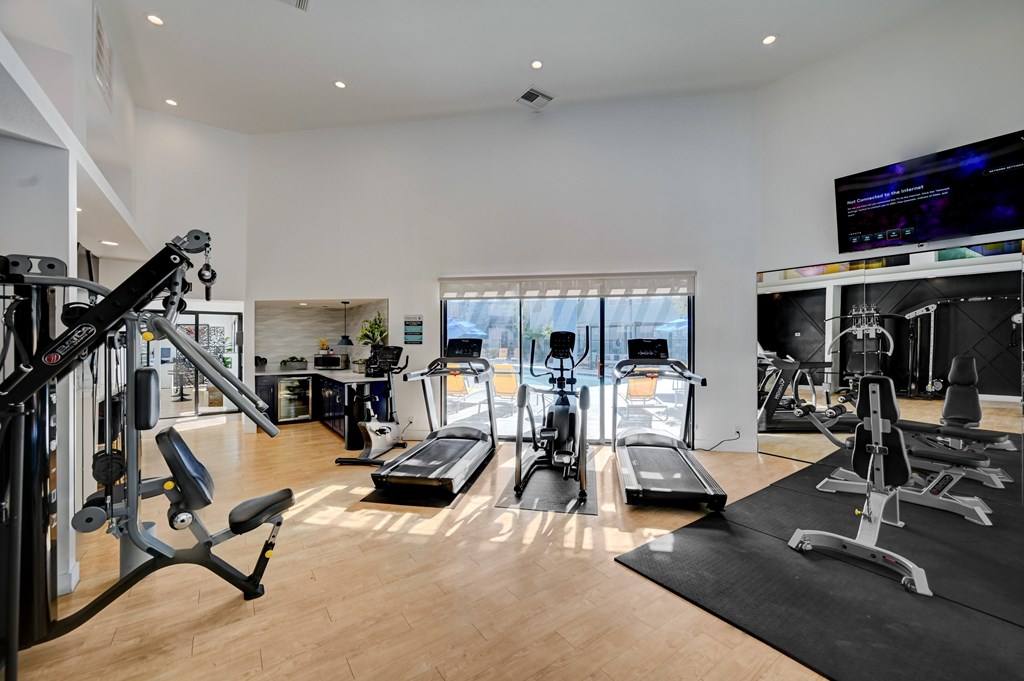 A well-equipped home gym with a variety of exercise machines.