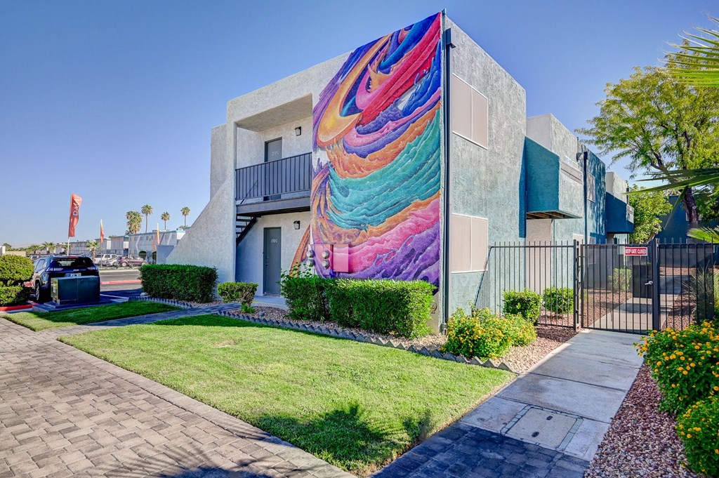 A modern house with a colorful mural on the side.