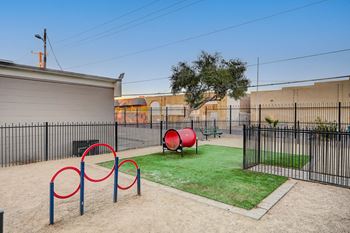 A playground with a red ball and a green bench.