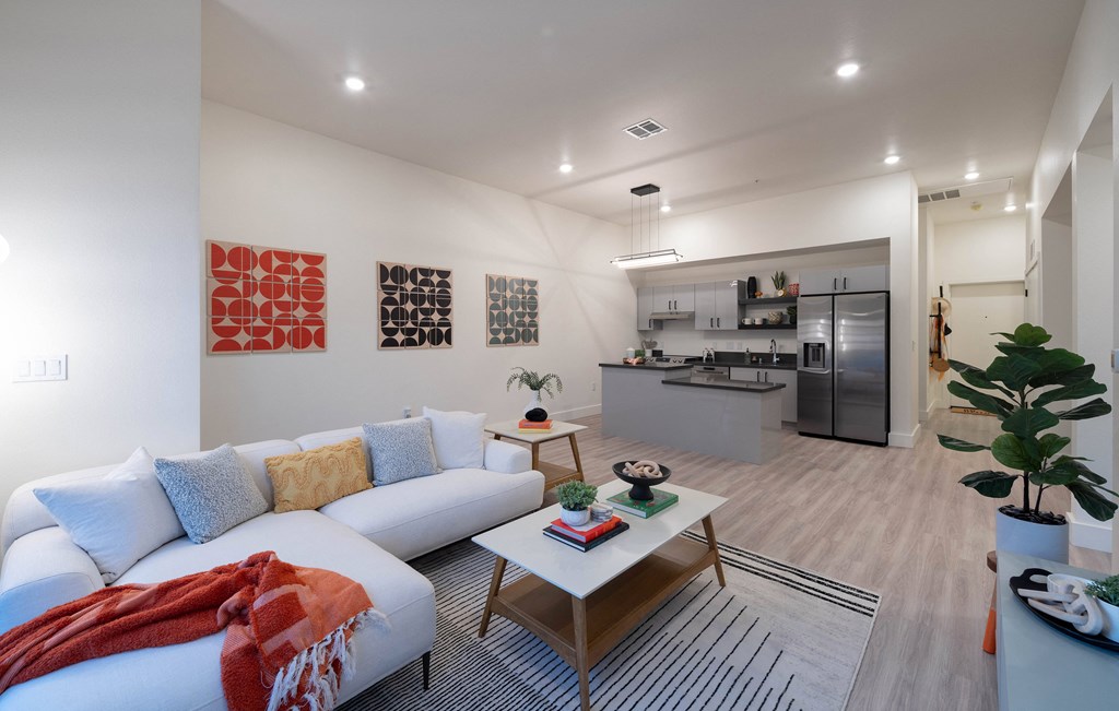 A living room with a white couch and a coffee table.