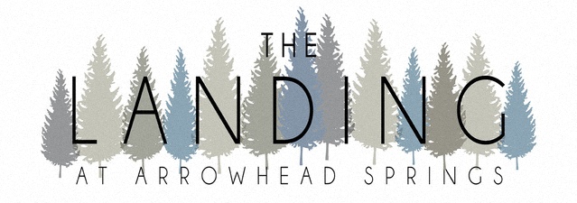 The image is a logo for "The Landing at Arrowhead Springs" with a forest of trees in the background.