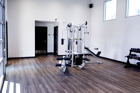 A gym with a variety of equipment including a leg press machine.