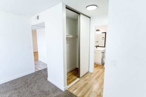 A white room with a doorway leading to another room.