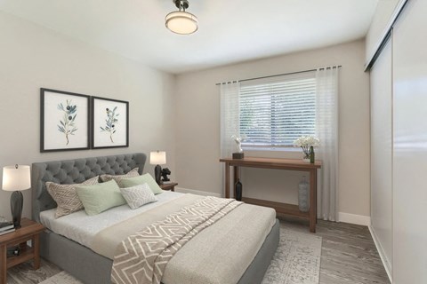 A bedroom with a large bed and a wooden table.