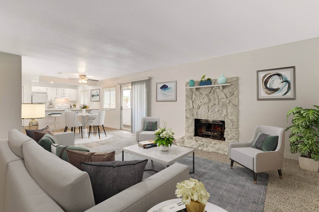 A living room with a fireplace and a dining table.