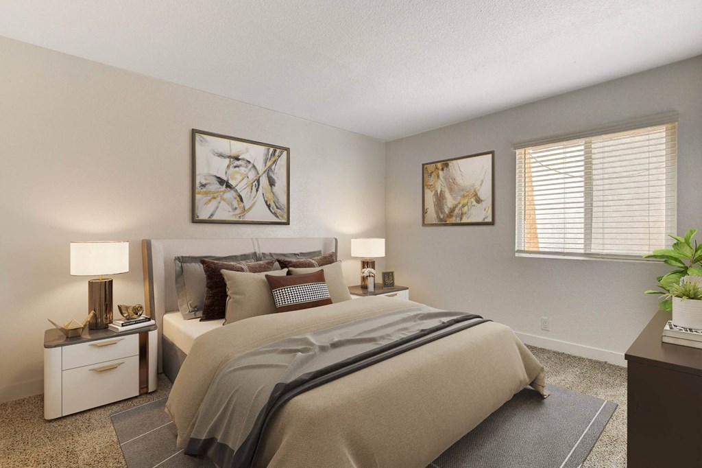 A bedroom with a large bed and two lamps on either side of it.