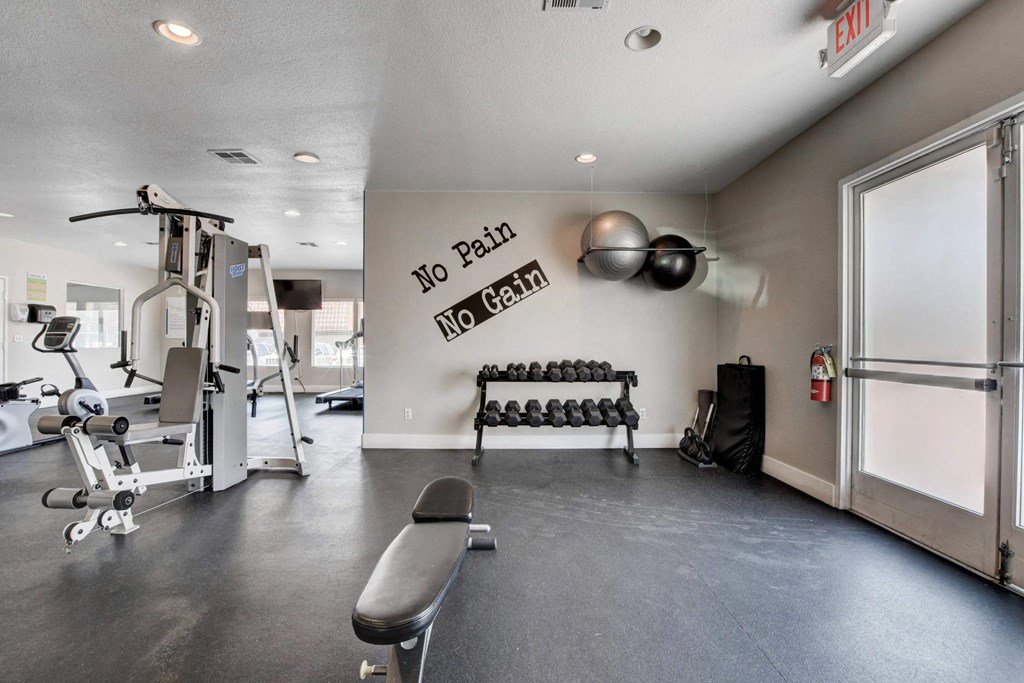 A gym with a sign that says "No Pain No Gain".