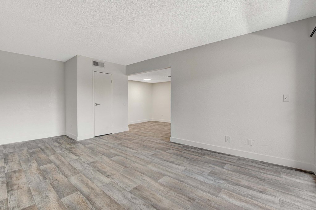 A room with a wooden floor and white walls.