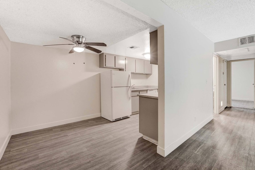 A room with a ceiling fan and a cabinet.