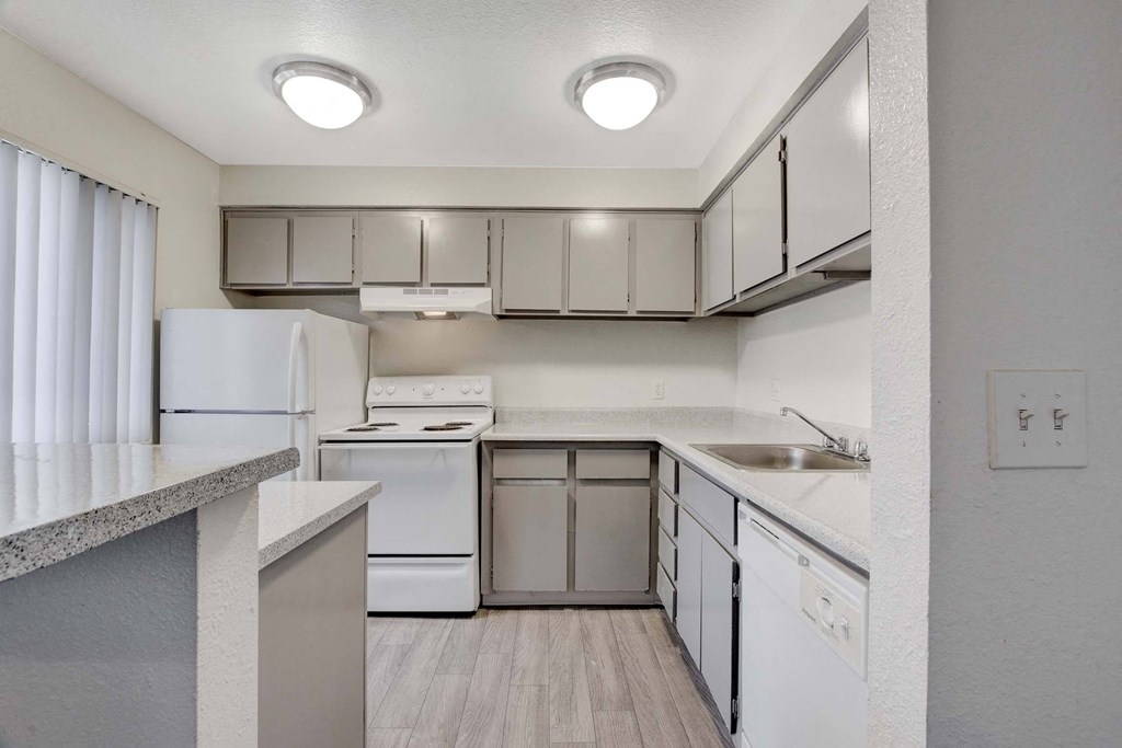 A kitchen with white appliances and a white refrigerator.