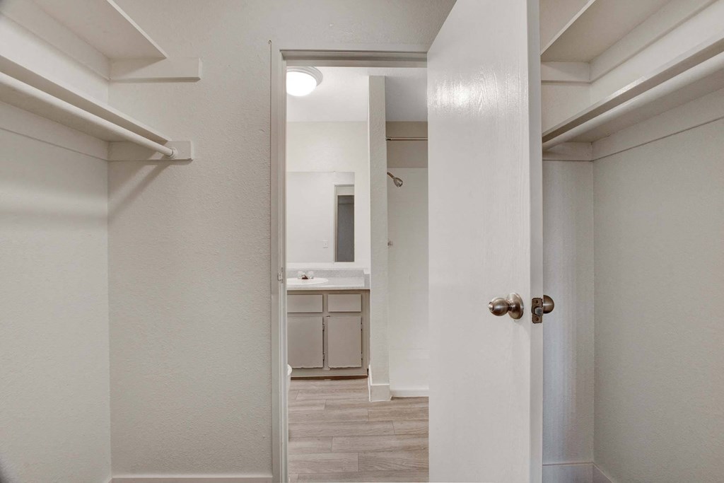 A white door is open to a kitchen.