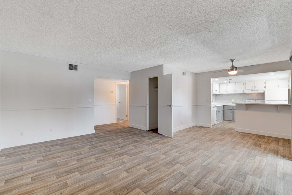A room with a wooden floor and white walls.