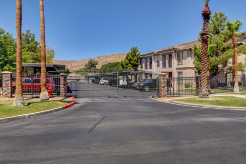 A street view of a residential area with palm trees and houses.