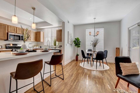 A kitchen with a table and chairs.