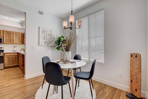 A dining room with a white table and chairs.