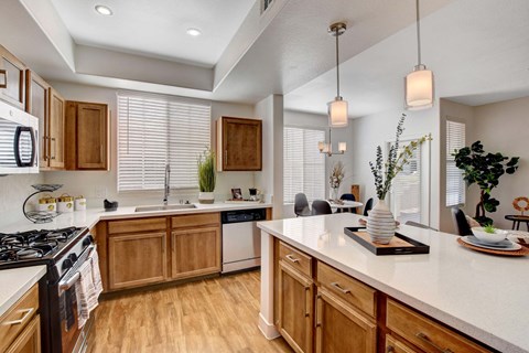 A kitchen with wooden cabinets and a white countertop.
