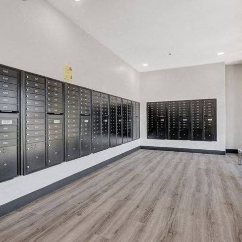 A room with a long row of mailboxes on the wall.