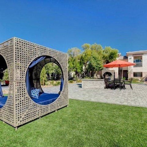 A modern outdoor seating area with a unique cube-shaped structure.