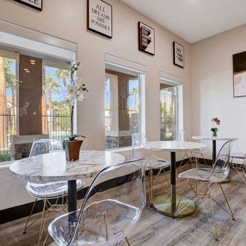 A dining room with a white table and chairs.