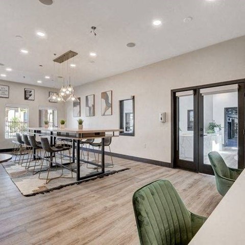 A modern dining room with a long table and chairs.