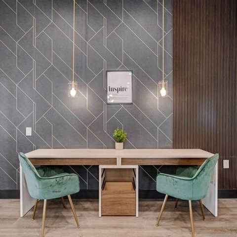 A modern dining room with a wooden table and green chairs.