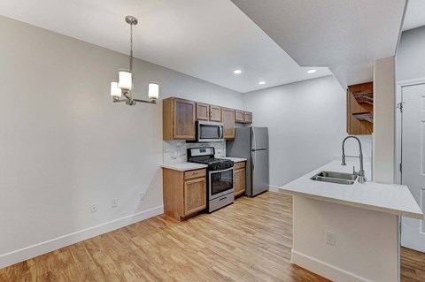 A kitchen with wooden floors and white walls.