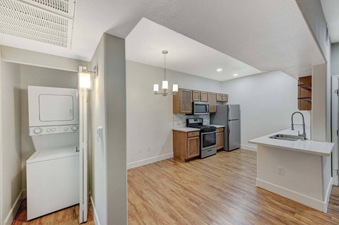 A kitchen with a white oven and a white sink.