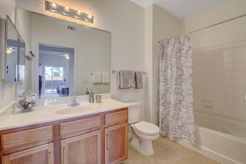 A bathroom with a sink, toilet, and shower.