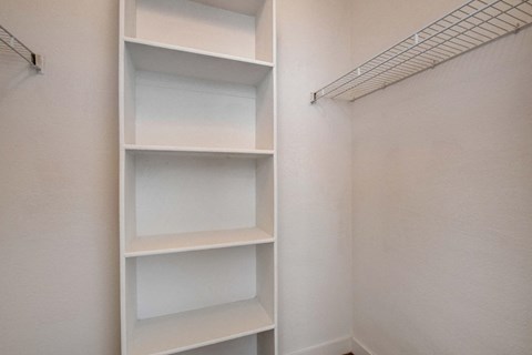 Empty white shelves in a room.