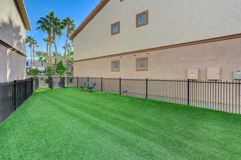 A house with a green lawn and a fence.