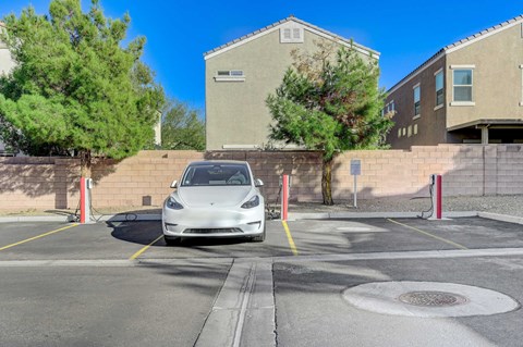 A white car is parked in a parking lot.